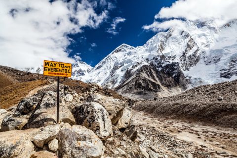 Footpath to Mount Everest Base Camp signpost in Himalayas, Nepal. Khumbu glacier and valley snow on mountain peaks, beautiful view landscape, Everest Base Camp Trek 12 Days