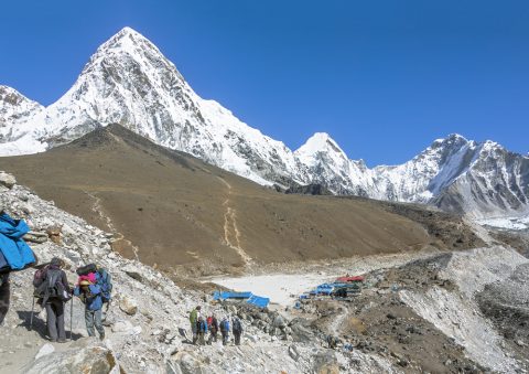 Tourists on the trek at the foot of mount Everest (8848 m) near Gorak Shep village - Nepal, Himalayas, Everest Base Camp Trek 12 Days
