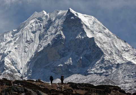 Trekkers against a snow covered Island peak, Island Peak & Everest 18 Days