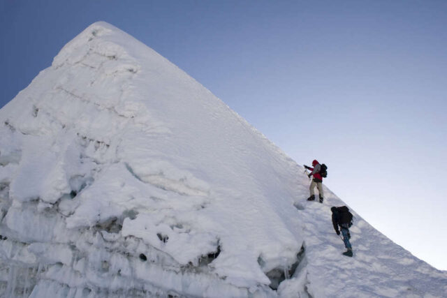 Climber reaching the summit of Island Peak
