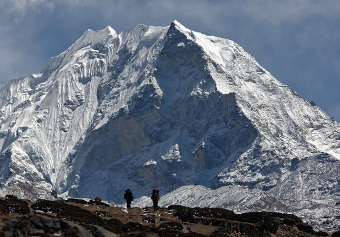 Trekkers in the Imja valley with a snow-covered Island Peak behind them